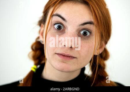 Close up portrait of innocent looking redhead pretty teenage girl. Stock Photo
