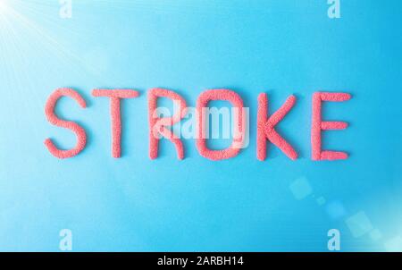 Stroke word in red letters on a blue background. Brain Vascular Stroke Disease Concept Stock Photo