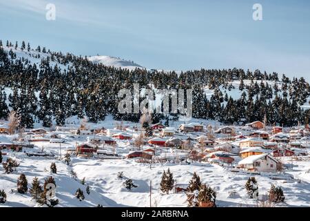 Houses covered with snow in a small village in Taurus mountains in winter Stock Photo
