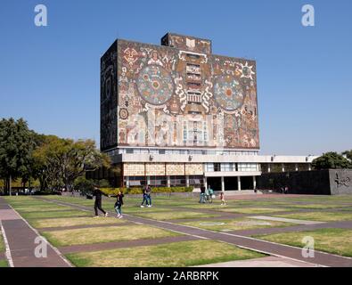 Mexico city University campus library iconic facade  created by the Mexican artist Juan O'Gorman with people walking by Stock Photo
