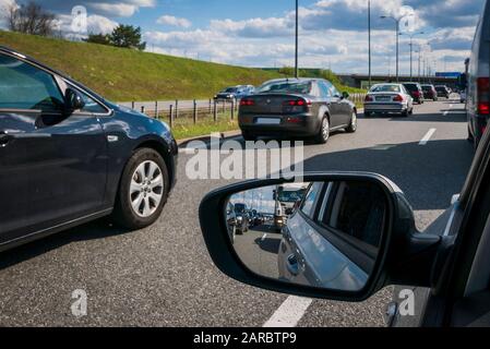 Traffic jam on motorway, front and rear view in car mirror. Stock Photo