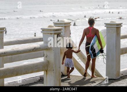 Mother and daughter getting ready to enjoy the waves. Sabang Beach is one of the exciting surf spots destination located in Baler, Aurora. It features a long stretch of gray shoreline and is an ideal surfing spot for beginners. (Photo by Herman Lumanog/Pacific Press) Stock Photo