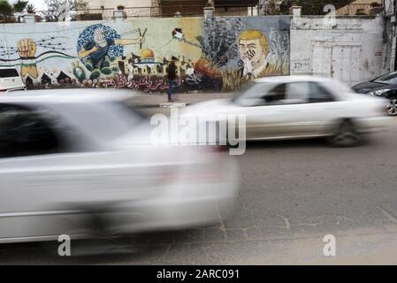 January 27, 2020, Gaza City, The Gaza Strip, Palestine: Wall painting by Palestinian protesters showing to the United States Donald J. Trump with a fingerprint on his face in the streets of Gaza City, Gaza Strip, on January 27, 2020 in Gaza City. - Palestinian Prime Minister Muhammad Shtayyeh today called on international powers to boycott an American peace plan that they see as biased towards Israel, as Israeli Prime Minister Benjamin Netanyahu and his political rival Benny Gantz are scheduled to meet with Donald Trump in Washington, and the American president expects to reveal his long-delay Stock Photo