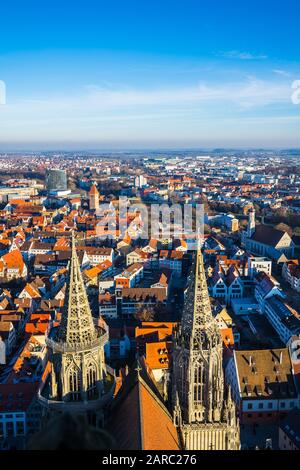 Ulm, Germany, December 29, 2019, Beautiful sunset light decorating view over skyline of ulm city from minster steeple with blue sky and sun Stock Photo