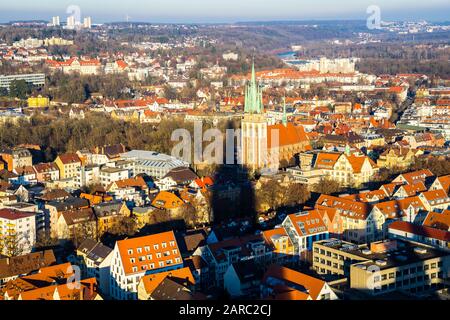 Ulm, Germany, December 29, 2019, Beautiful aerialv view above red roofs, skyline and church building of st george in warm sunset light Stock Photo