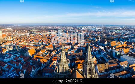 Ulm, Germany, December 29, 2019, XXL panorama view over skyline and church steeple of ulm city from cathedral spire with blue sky and sun Stock Photo