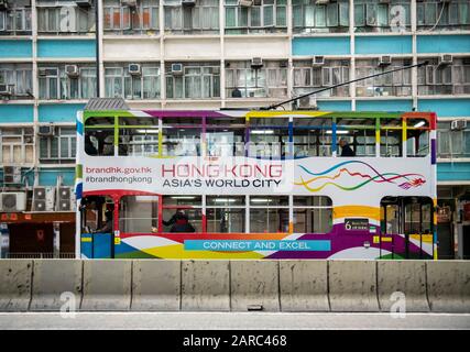 Hong Kong,China:27 Jan,2020.   A Hong Kong tram advertising Asias World City, passes through North Point. Many people say the slogan needs an update f Stock Photo