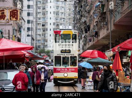 Hong Kong,China:27 Jan,2020.   A Hong Kong tram makes its way through the crowds at the Chun Yeung Street market on the way to the terminus. The tram Stock Photo