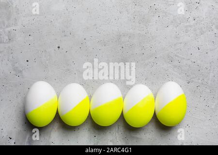 Colored Easter eggs on gray background with copy space Stock Photo