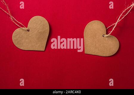 Brown heart-shaped label on red background Stock Photo