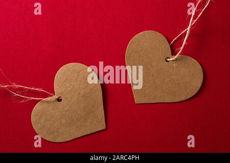 Brown heart-shaped label on red background Stock Photo