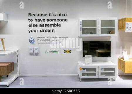 A sign in an IKEA store promotes TaskRabbit to assemble their flatpack furniture. Stock Photo