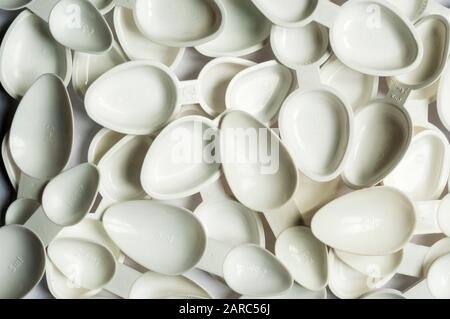 Plastic medicine dosage spoons for measuring 5ml and 2.5ml quantities of liquid medicines. Stock Photo