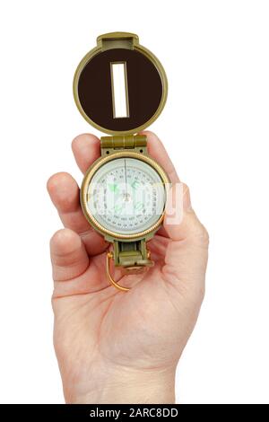 The hand holds the compass on a white background, isolate. Stock Photo