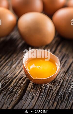 Fresh raw eggs on rustic wooden table Stock Photo
