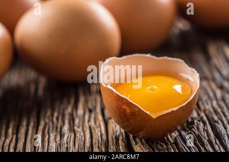 Fresh raw eggs on rustic wooden table Stock Photo