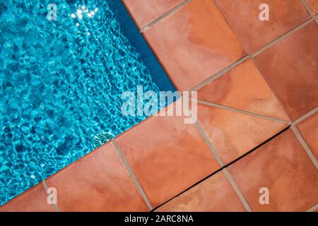 Swimming pool border and tiled terrace floor,  closeup of terracotta tiles Stock Photo