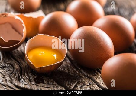 Fresh raw eggs on rustic wooden table Stock Photo