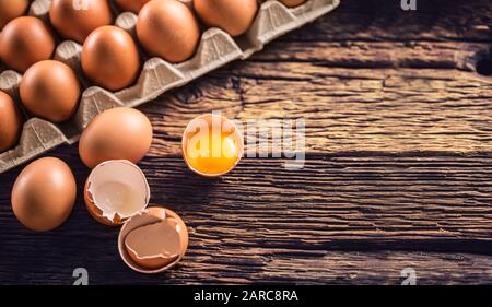 Fresh raw eggs on rustic wooden table - Top of View Stock Photo