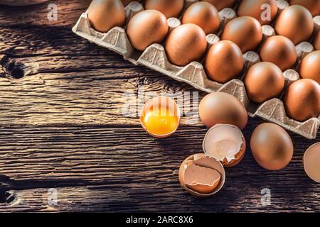 Fresh raw eggs on rustic wooden table - Top of View Stock Photo