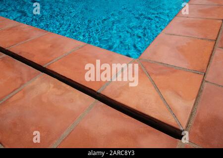 Swimming pool border and tiled terrace floor,  closeup of terracotta tiles Stock Photo