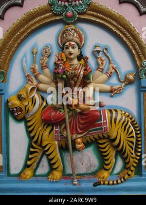 Vertical shot of a Hindu god sculpting on the wall Stock Photo