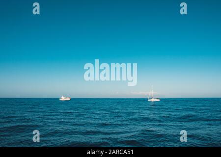 Ocean horizon with sailboats, two sailing  boats  on whale watching tour - Stock Photo