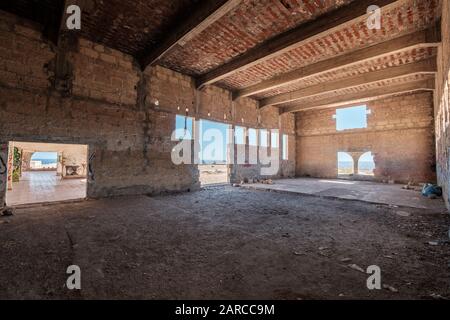 inside of abandoned warehouse or industrial ruin - run down building , empty space Stock Photo