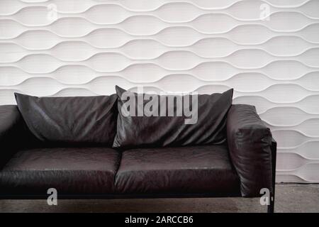 Black leather sofa on a white background in studio Stock Photo