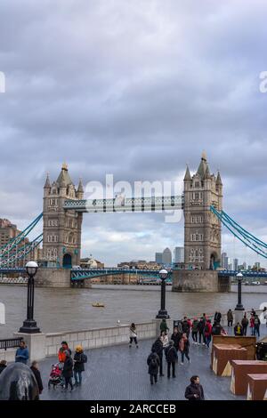 London, UK - December 13 2020: Unidentified people around Tower bridge over the River Thames Stock Photo