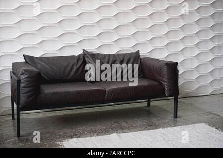 Black leather sofa on a white background in studio Stock Photo