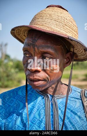 Portrait of a fulani man with facial tattoos and a hat. Stock Photo