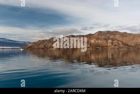 The tranquil waters of Rypefjord in east Greenland Stock Photo
