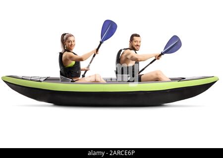 Profile shot of a young man and woman with safety vest paddling in a canoe isolated on white background Stock Photo