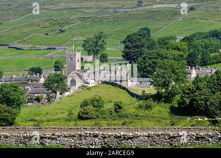 The village of Askrigg set against the moorlands of the Pennines hills, on a summers day, Wensleydale Yorkshire England UK Stock Photo