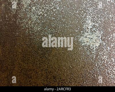 Plaster with the effect of rust and irregularities on the wall in brown tones. Stock Photo