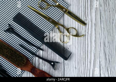 Scissors and combs on a beautiful striped towel, hairdresser concept. Top views with clar space Stock Photo