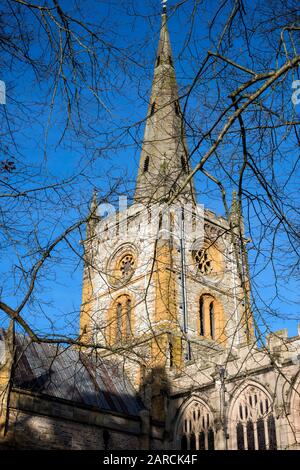 The Church of the Holy and Undivided Trinity, with spire,  Stratford on Avon, England, UK against blue sky. Stock Photo