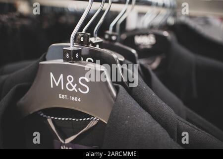 Marks & Spencer clothing rail in a store. M&S is a British high Street store brand renowned for its clothing and high quality food Stock Photo