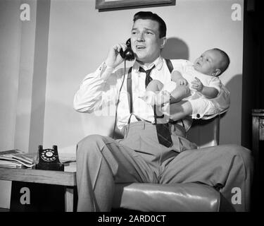 1950s DISTRESSED FATHER HOLDING BABY WHILE TALKING ON TELEPHONE - b807 DEB001 HARS PAIR SUBURBAN URBAN EMERGENCY RELATIONSHIP OLD TIME BUSY NOSTALGIA OLD FASHION 1 JUVENILE FEAR COMMUNICATION BALANCE TEAMWORK INFANT WORRY PANIC SONS LIFESTYLE PARENTING CALL RELATION HOME LIFE COPY SPACE FULL-LENGTH HALF-LENGTH PERSONS CARING CRY MALES AFRAID CALLING DIAPER FATHERS B&W CONCERNED SINGLE PARENT FATHERHOOD DADS EXCITEMENT STRESSFUL DIAPERS BAREFOOT CONCERN PHONES PEOPLE BABIES BUSINESS MAN TELEPHONES BOOTIE FEARFUL DEB001 BABY BOY BABY-SITTER BABY-SITTING BOOTY JUVENILES MID-ADULT MID-ADULT MAN Stock Photo