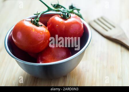 Fresh tomatoes in bowl Stock Photo