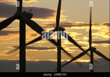 Part of the Kelmarsh wind farm just after sunset, Northamptonshire. Stock Photo