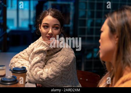 Caucasian Woman Listening Asian Woman In Cafe And Drinking Coffee. Concept Of Multiracial And International Friendship. Stock Photo