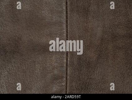 dark brown leather material background with sewing stitches, close up Stock Photo