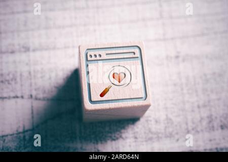 A Searching For Love On The Internet Concept With A Browser And Magnifying Glass Engraved On A Wooden Block On A Table Stock Photo