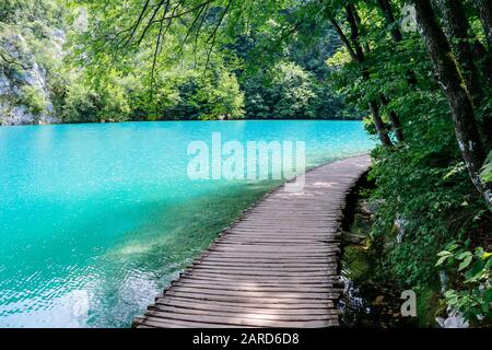 Wooden walkways beside the turquoise waters in Plitvice Lakes National Park in Croatia Stock Photo
