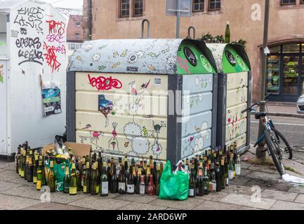 Many empty bottles staying near the garbage collection bin after the holiday Stock Photo