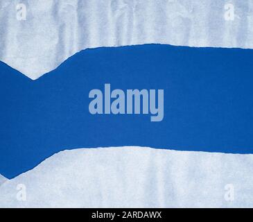 blue background with white crumpled torn paper elements, place for writing op in the middle, template Stock Photo