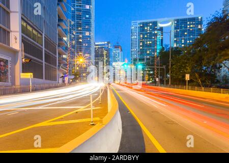 City skyscrapers and trail lights at dusk in Downtown Miami, Miami, Florida, United States of America, North America Stock Photo