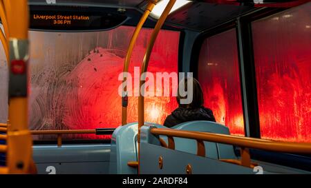 London Bus Top Deck Rain. In rainy weather Red Traffic lights are diffused by the wet windows of a New Routemaster Bus in Central London Stock Photo